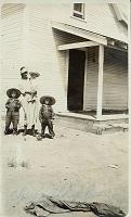  From left to right, Lester Henry Turner (son), Bulah Speed Turner (mother) holding Charles Edward Turner (son), and Wesley Woodson Turner (son) at Chenault Ranch house.